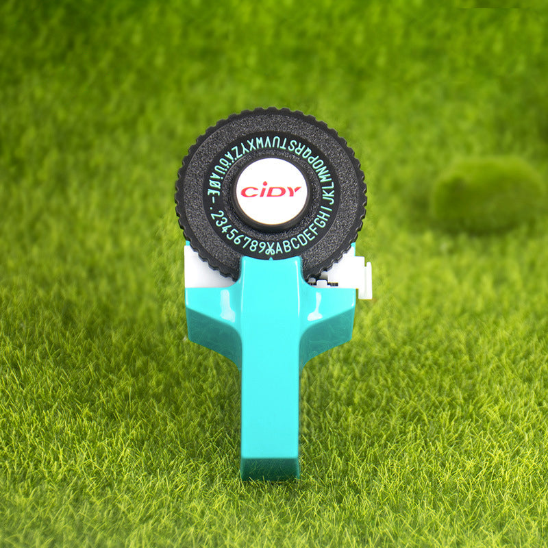 Blue embossing label maker on grass background