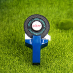 Dark blue embossing label maker on grass background