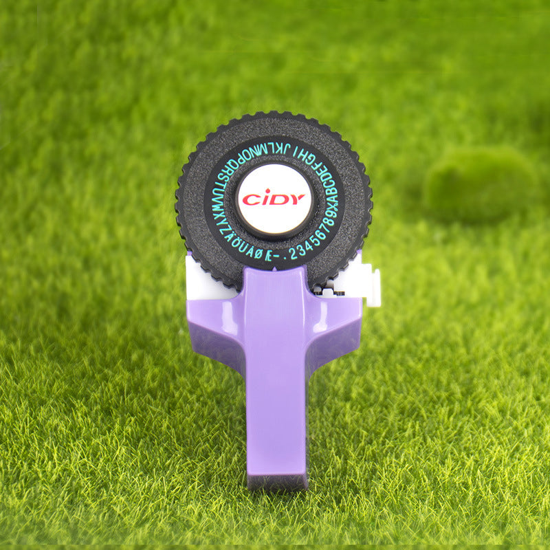 Purple embossing label maker on grass green background