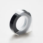 Black embossing tape refill roll for manual label makers
