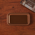 Vintage iron box ink pad in Fallen Leaf open on wood, autumn leaf lid beside