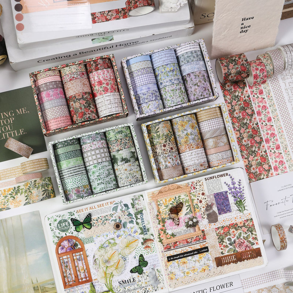 Complete Floral Whisper washi tape collection showing four vintage botanical themes in a decorative box, displayed on a floral journal spread with butterfly stickers and pressed flowers