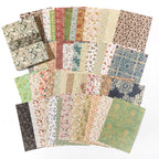 Fanned decorative paper sheets with small repeating florals, damask patterns, and vintage wallpaper prints in soft pastel tones.