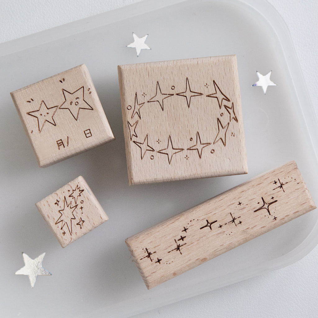 Four vintage star beech wood rubber stamps with natural wood grain and carved rubber constellation surfaces, pre-cut celestial stamps for planner spreads