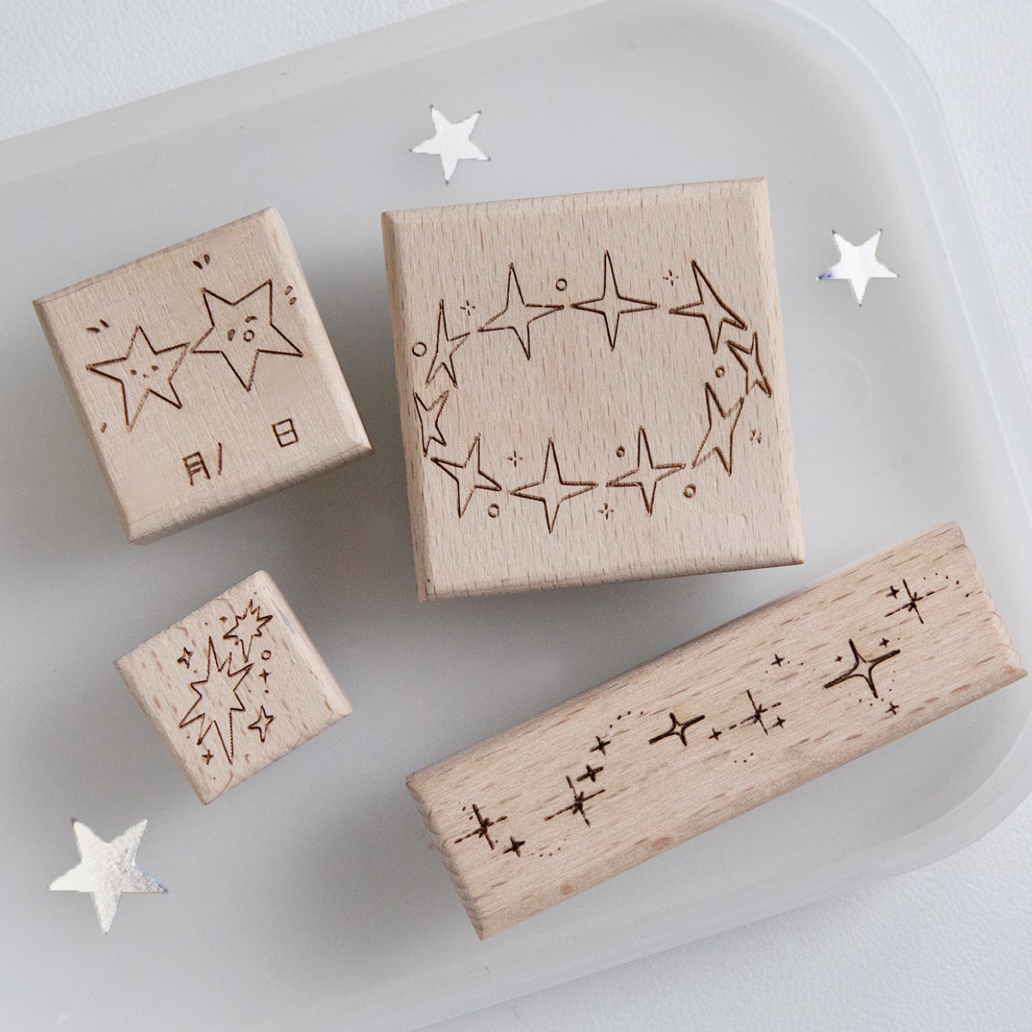 Four vintage star beech wood rubber stamps with natural wood grain and carved rubber constellation surfaces, pre-cut celestial stamps for planner spreads