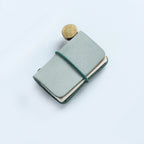 Green frosted wax leather mini traveler's notebook charm with elastic band and vintage metal clasp