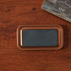 Vintage iron box ink pad in Galaxy Grey open on wood, grey starry lid beside
