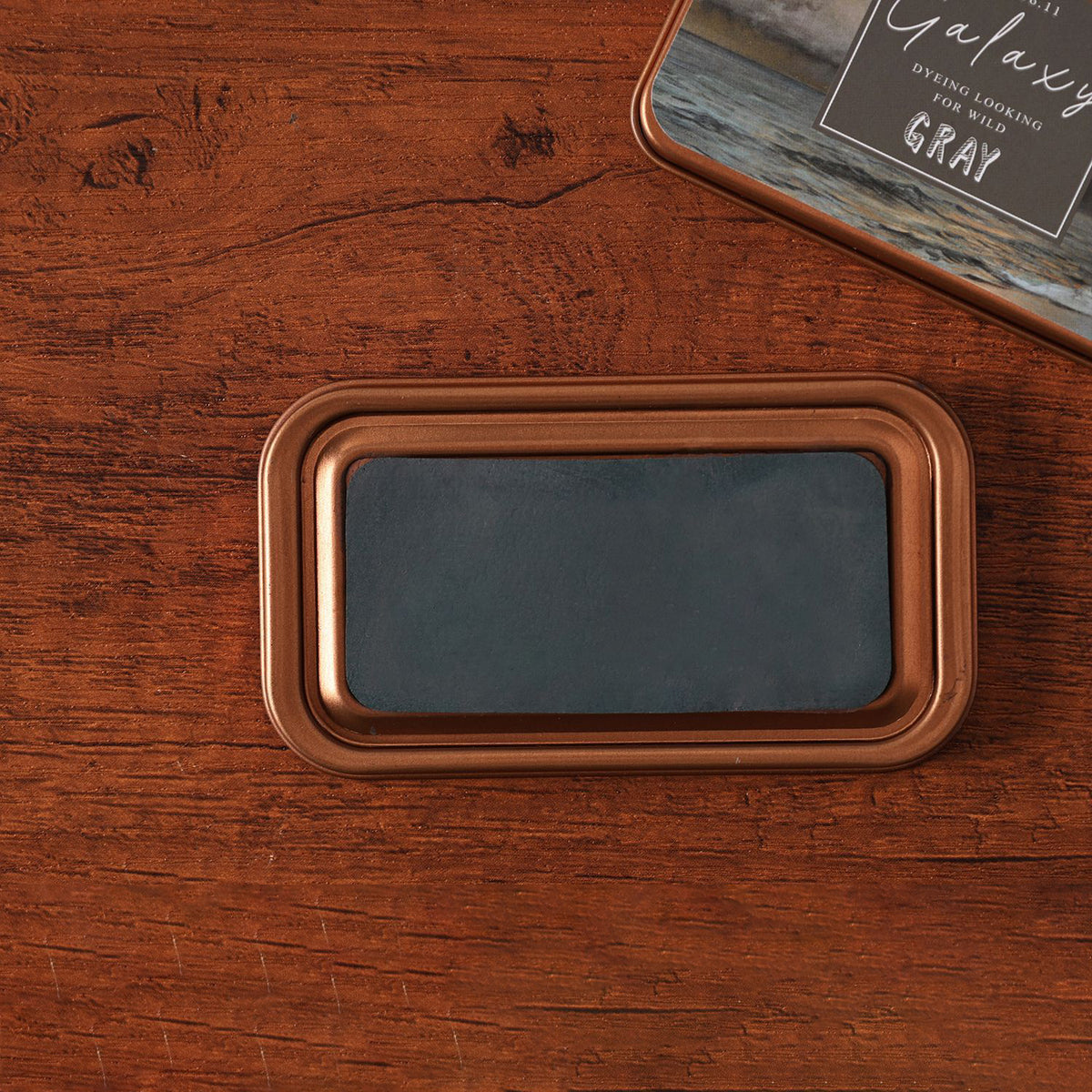 Vintage iron box ink pad in Galaxy Grey open on wood, grey starry lid beside