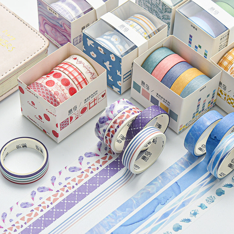 Ten boxes of geometric washi tape sets arranged with rolls unrolled showing patterns