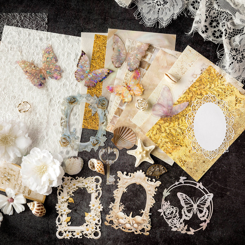 Variant image of the Gilded Sands style Premium Mixed Media Junk Journal Kit in its opulent champagne gold packaging. Shows the 30 baroque and rococo pieces including large laser-cut frames, holographic PET pearl chains and flourishes, and premium textured background papers.