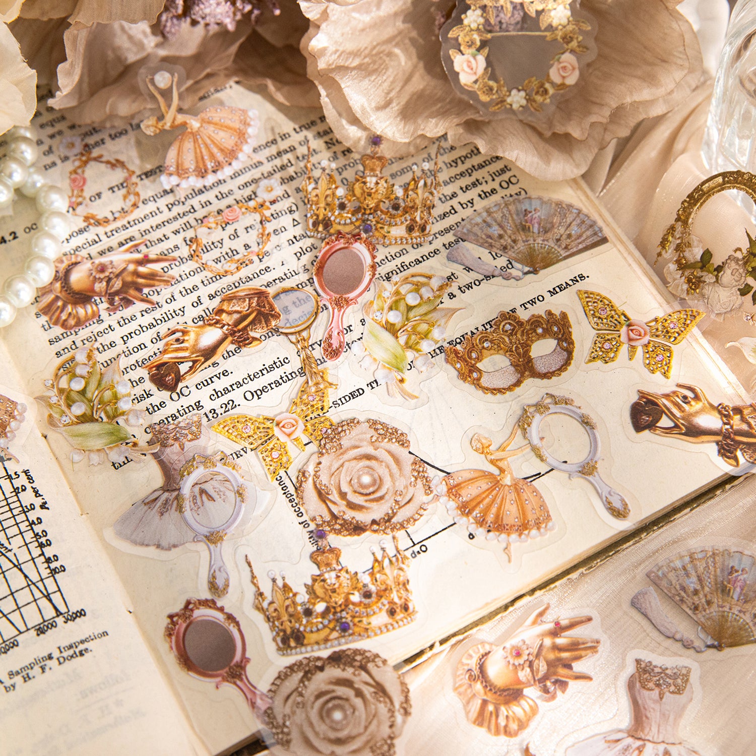 Vintage gilded PET stickers layered over open book pages with ballet dancers, crowns, hand mirrors, and roses among pearls and dried flowers.