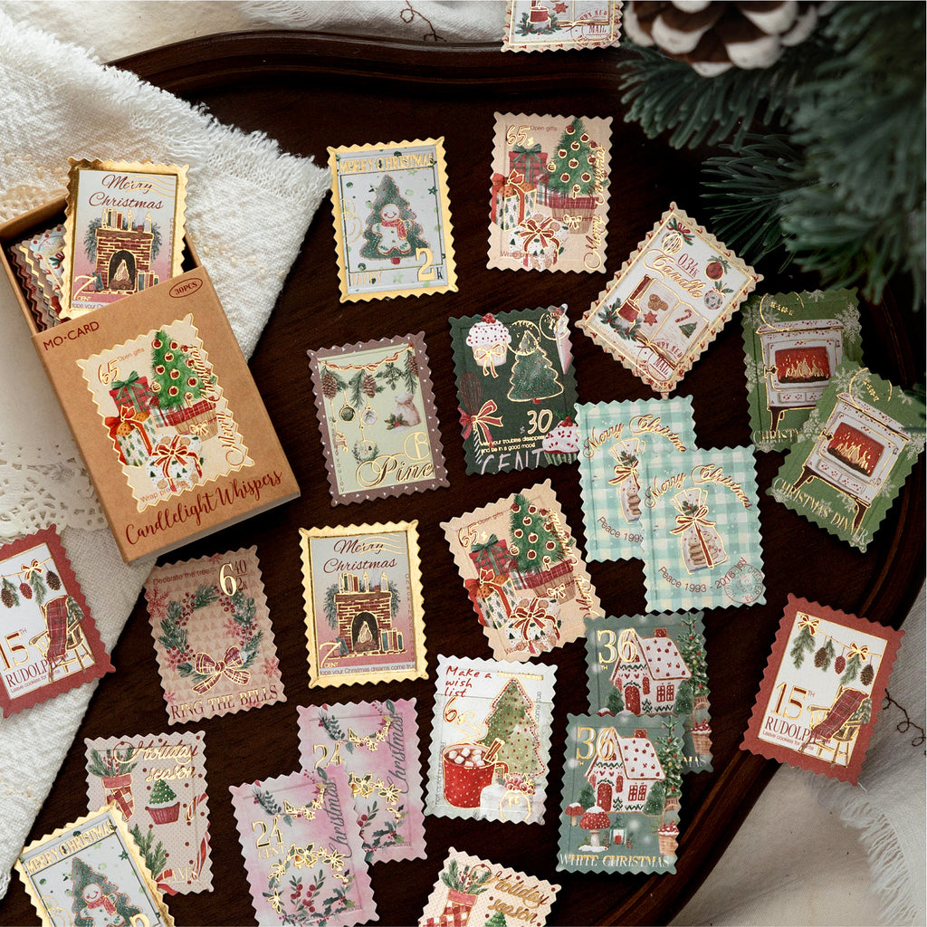 Golden Bells and Elk Christmas stickers spread across a vintage desk with lace and greenery