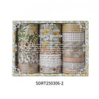 Close-up of Golden Harvest warm earth-tone washi tape rolls, featuring vintage botanical and grid patterns in amber and sepia shades