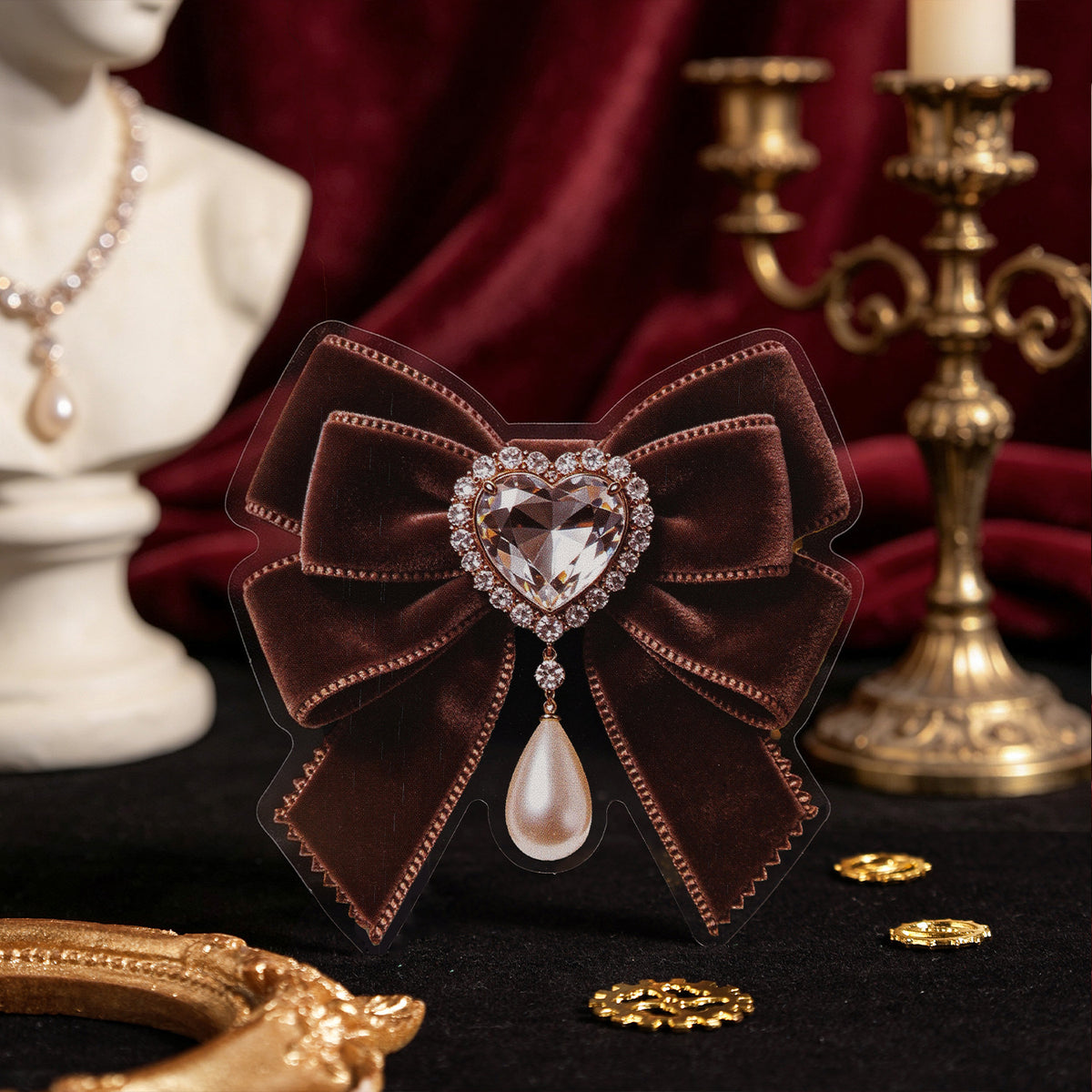 Gothic burgundy bow sticker with pearl cameo brooch styled on red velvet with brass candelabra