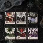 Gothic spider web sticker packs in six dark styles arranged on black web fabric