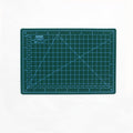 Green A5 self-healing cutting mat with white grid lines and inch rulers