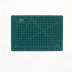 Green A5 self-healing cutting mat with white grid lines and inch rulers