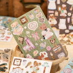 Open green teddy bear sticker book with soft-touch laminated sheets visible