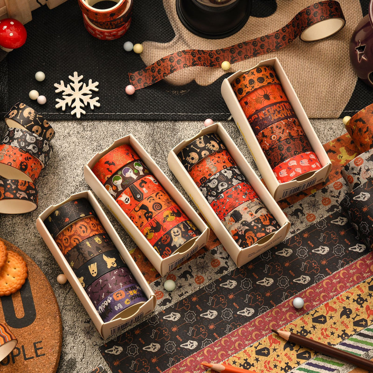 Halloween washi tape mini gift boxes in four designs styled with autumn props, candles and cookies