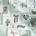 All eight handmade lace acrylic stamp designs arranged in a flat grid – bow, heart, lamp, bear, lily, lace trims