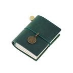 Hunter green crazy horse leather pocket-sized traveler's notebook with rustic texture and bronze pendant
