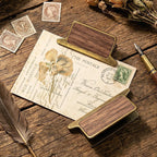 Walnut wood clip holding botanical journal page flat in use