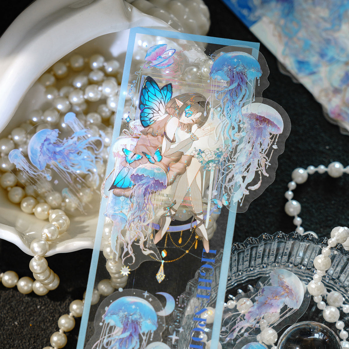 Jellyfish stickers glowing beside shells on dark background 