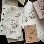 Vintage journal spread with stamped butterfly trail, poetic text impressions, and beech wood rubber stamp on textured paper background, junk journal ephemera