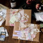 Vintage ephemera kit packed in kraft envelopes with twine and butterfly cutouts for gifting