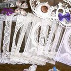 Hands holding translucent lace sticker pieces with scalloped edges