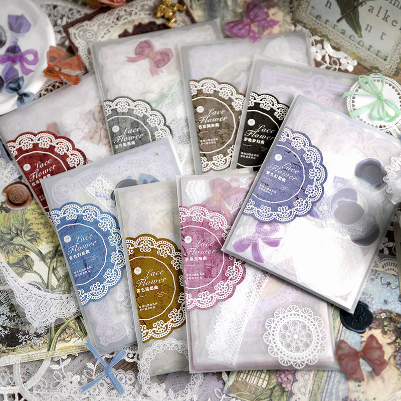 Lace fantasy sticker packs scattered on a vintage desk