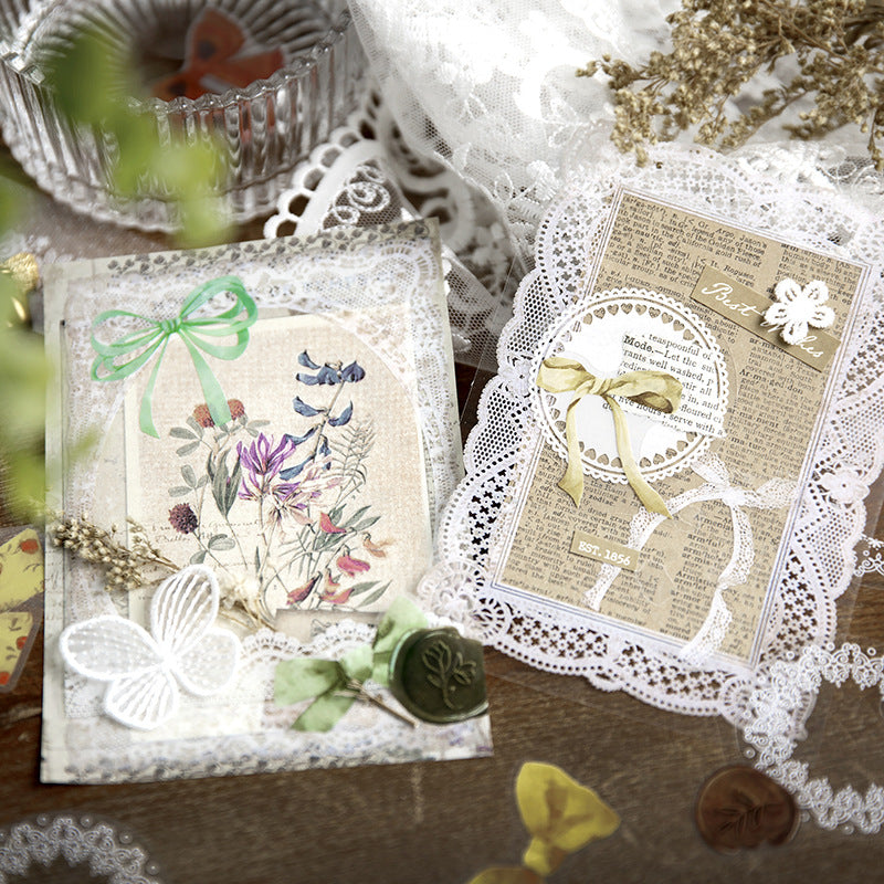 Lace stickers layered into an open journal spread