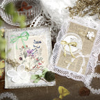 Lace stickers layered into an open journal spread