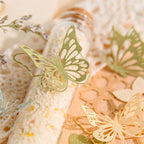 Vintage garden themed paper pack showing detailed floral patterns and butterflies