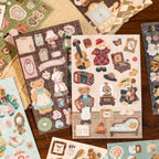 Manor Chronicles teddy bear sticker sheets spread on vintage desk with brown tones