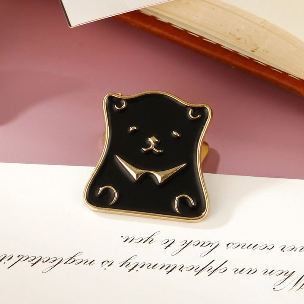 A matte onyx black vintage bear head metal paper clip displayed on aesthetic paper, adding a whimsical and retro touch to desk setups and journal spreads.