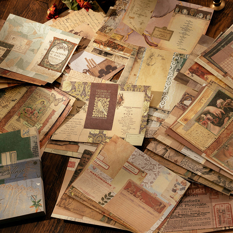 Scattered mixed vintage paper sheets with antique advertisements, botanical prints, and timeworn ephemera on a dark wooden surface.