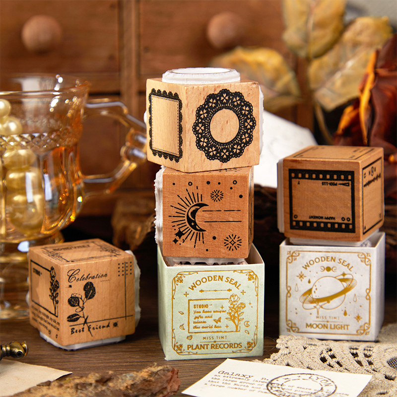 "Vintage wood stamp set showing detailed moon and star patterns for journaling"