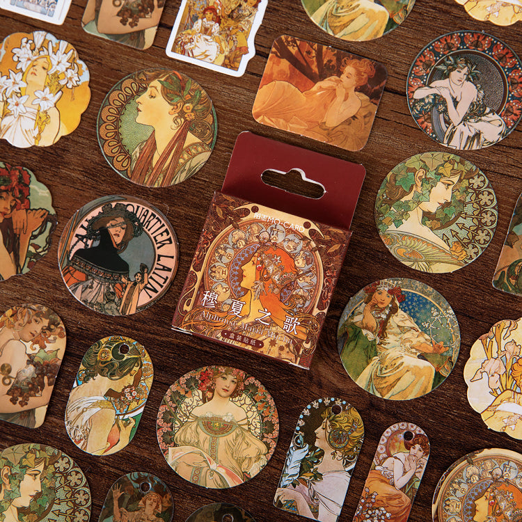 Close-up of Alphonse Mucha inspired Japanese style stickers with Art Nouveau designs for vintage crafts
