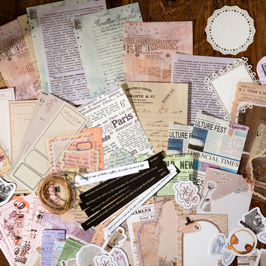 Vintage ephemera kit spread with newspaper clippings, tickets, tags, and sentiment strips for journaling