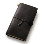 Obsidian Black premium genuine leather travel diary adorned with a classic Statue of Liberty metal pendant.