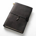 Obsidian Black full-grain leather A5 journal featuring a Statue of Liberty charm, the perfect executive notebook for office professionals.