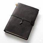 Obsidian Black full-grain leather A5 journal featuring a Statue of Liberty charm, the perfect executive notebook for office professionals.