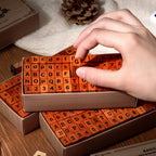 Hand picking a wooden letter stamp from the kraft storage box, orange rubber face
