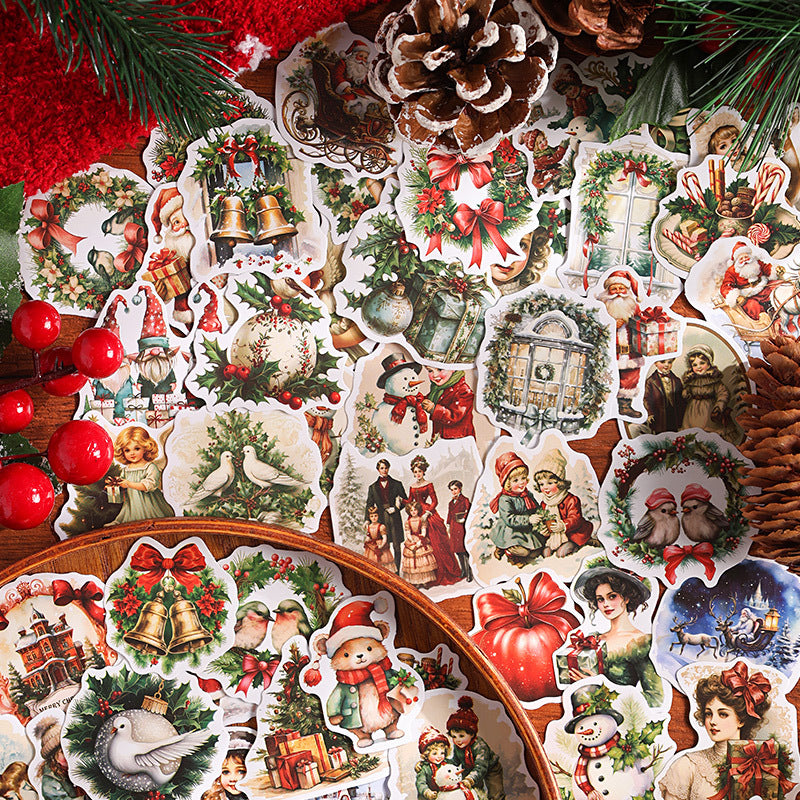 Close up pile of vintage Christmas sticker flakes with wreaths angels and retro holiday characters in red and green