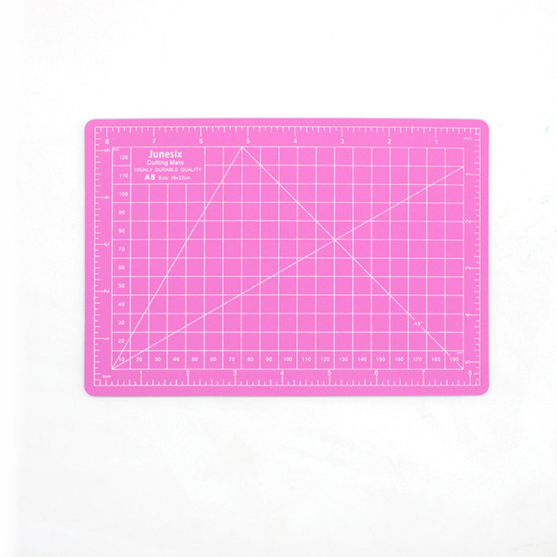 Pink A5 self-healing cutting mat with grid lines and inch rulers