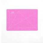 Pink A5 self-healing cutting mat with grid lines and inch rulers