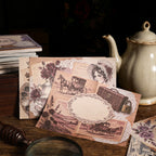 Pink-toned vintage papers with teapot and stationery props