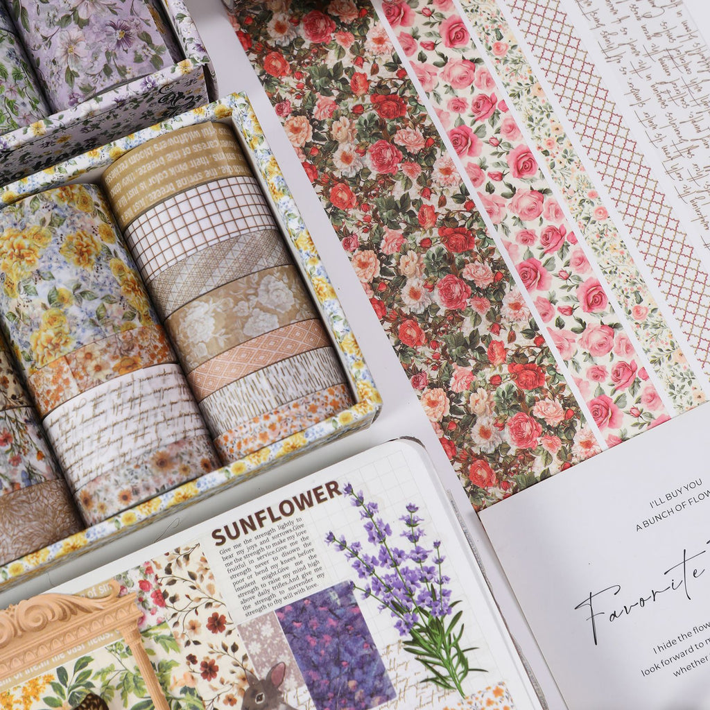 Floral Whisper purple lavender washi tape set opened in its box, showing assorted width rolls with vintage botanical patterns and dried lavender accents