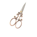 Vintage scroll scissors with ornate vine handles in red copper finish